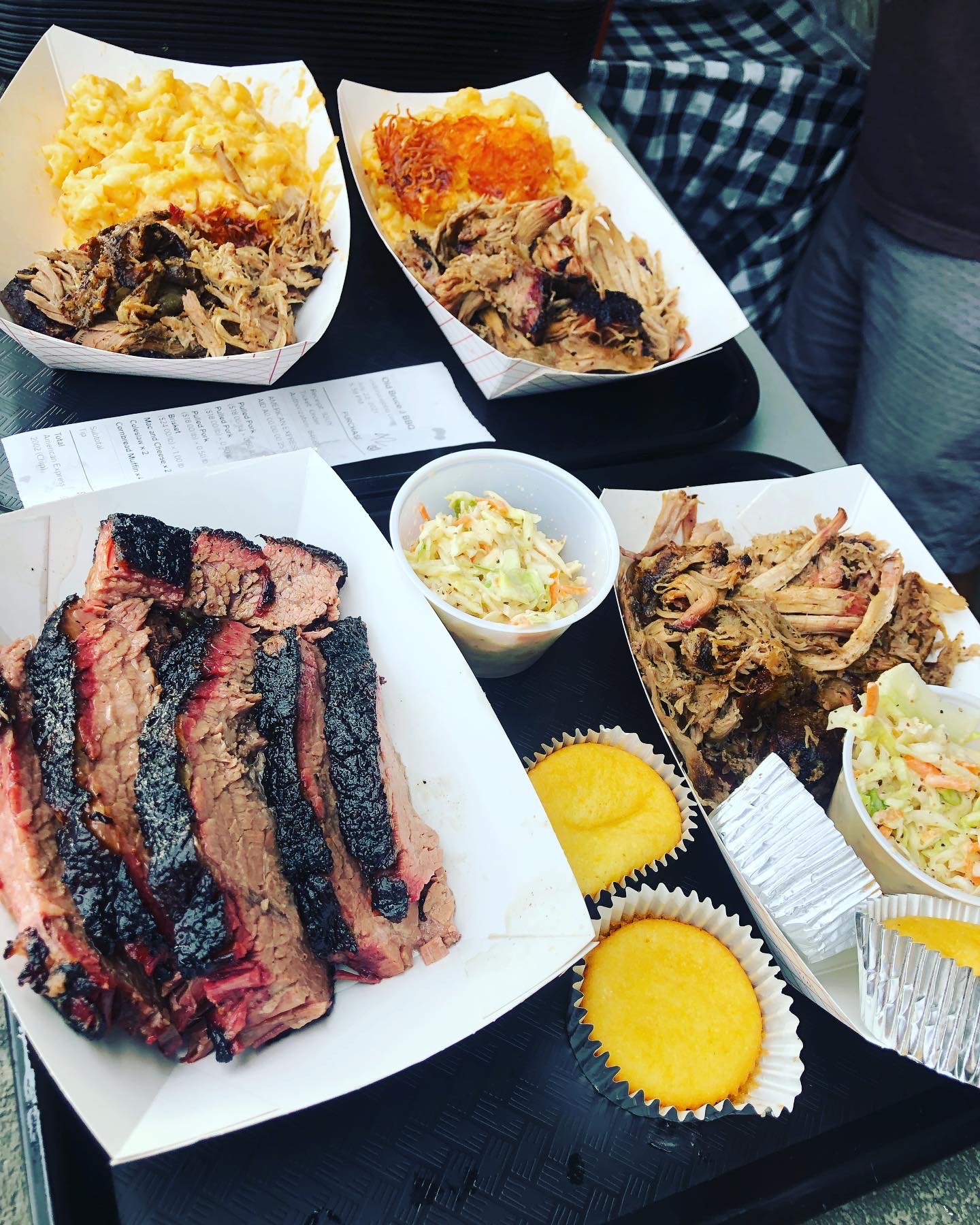 A tray of smoked ribs, brisket, baked beans, coleslaw and cornbread